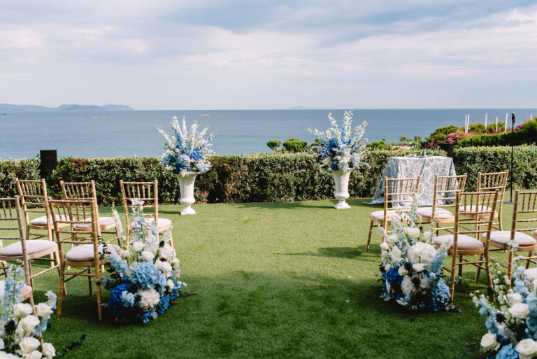 Wedding ceremony chairs arranged on lawn overlooking the sea at Athens Riviera wedding venue
