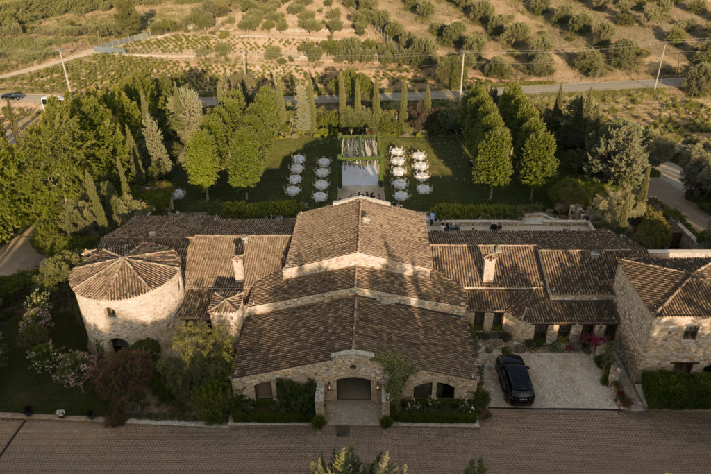 Stunning aerial image of castle venue and garden wedding arrangements in Athens